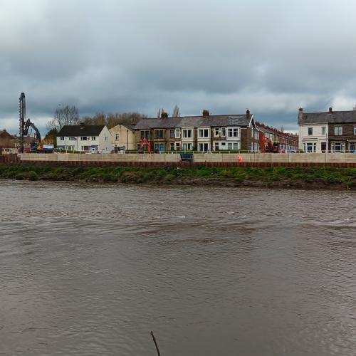 Picture of new wall units installed along Riverside, with houses in the background.