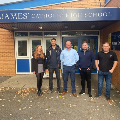Men and women stood outside a school entrance