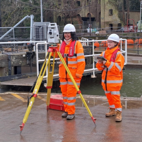 Two people on site smiling.