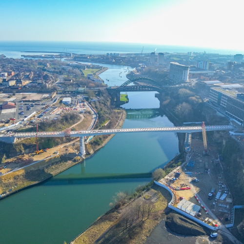 aerial of footbridge in construction across the river