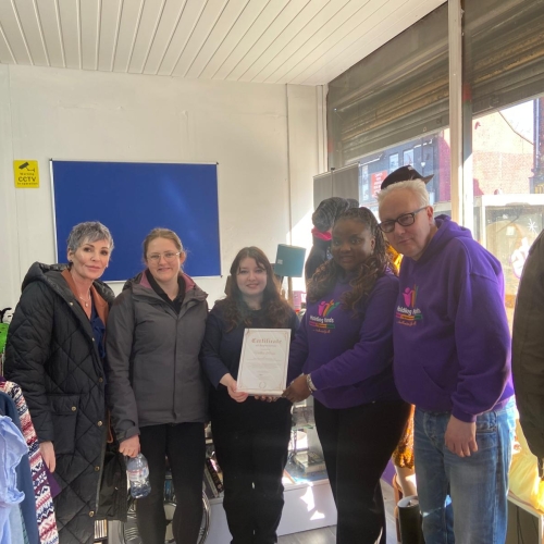 People stood in a charity shop