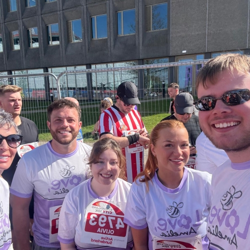 Picture of five people smiling in the sun