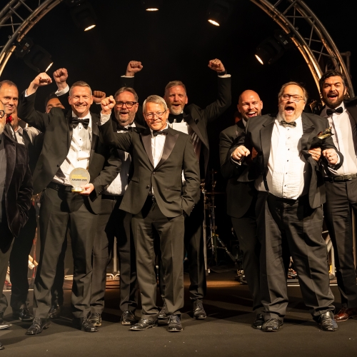 People in suits on a stage.