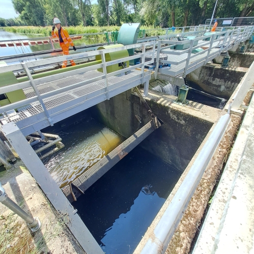 A man walking over a bridge.