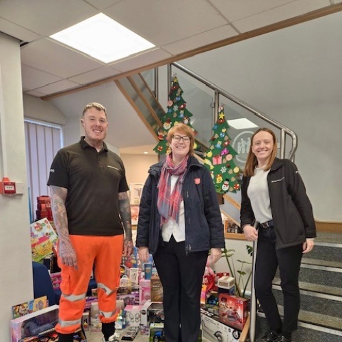 People stood with gifts for a charity.