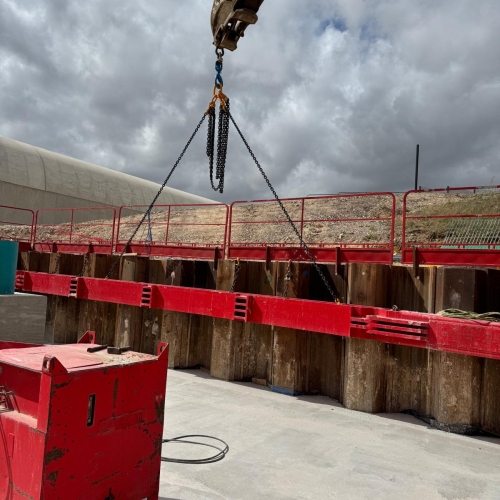 Crane lifting piles.