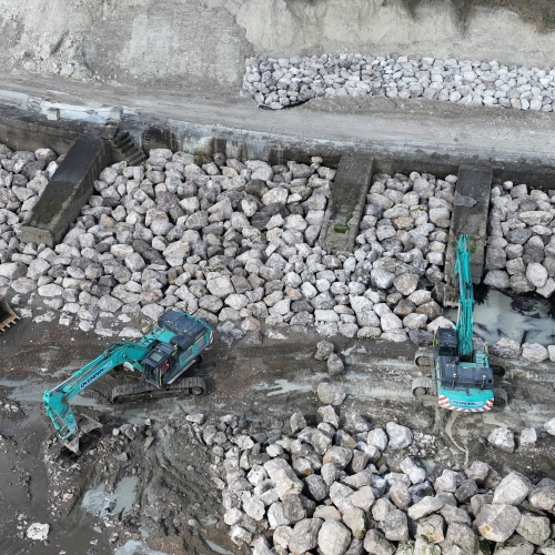 Picture of two diggers moving rocks.