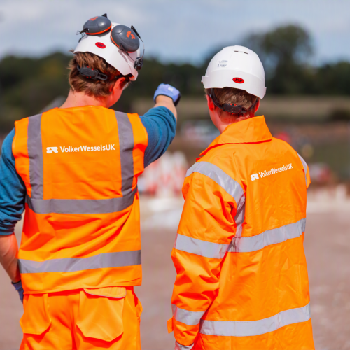 Two men in highvis pointing