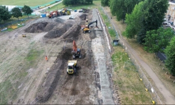Picture of a field with a dumper truck.