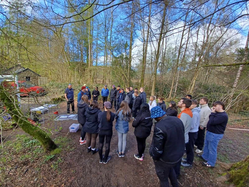 A group of people stood in the woods