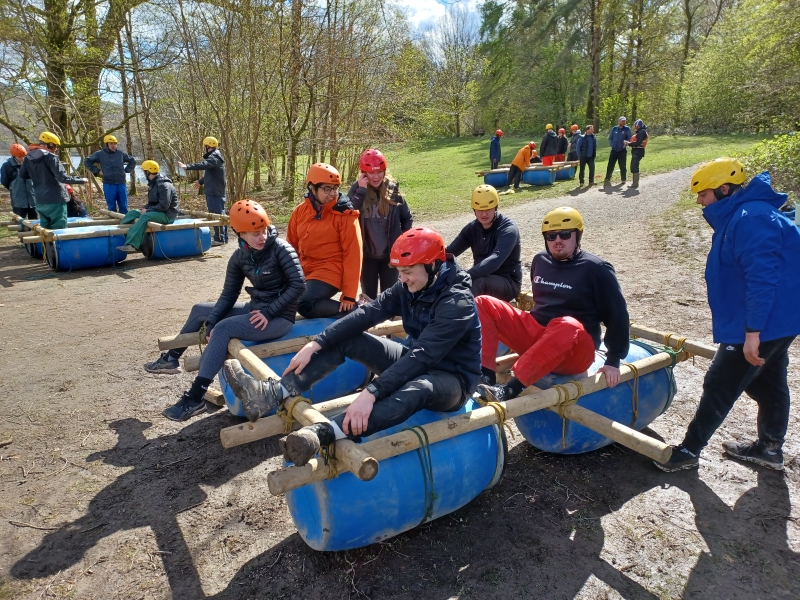Group of people sat in a homeade raft