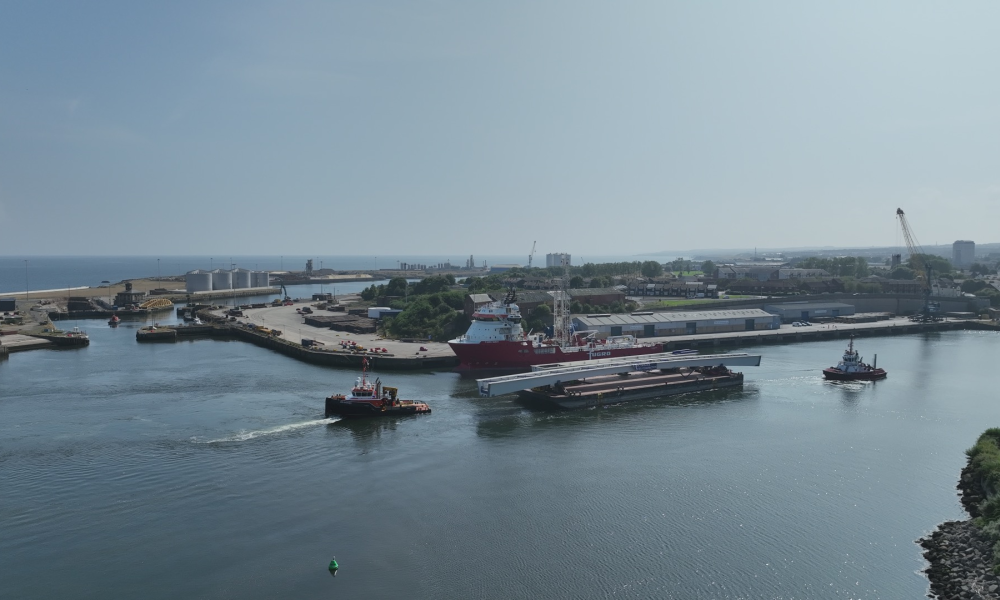 Footbridge sections on a barge sailing through a port
