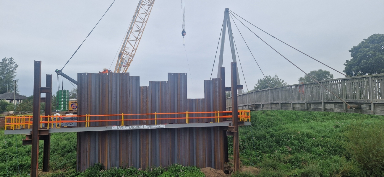 Crane lifting piles into place