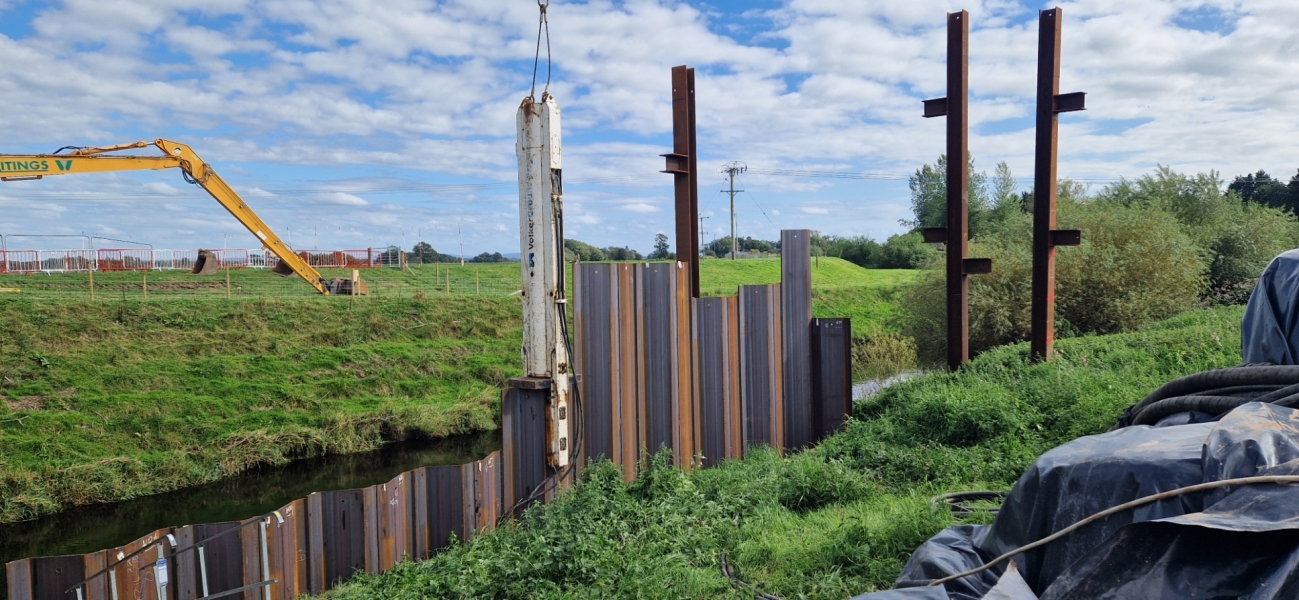 Crane lifting piles into place