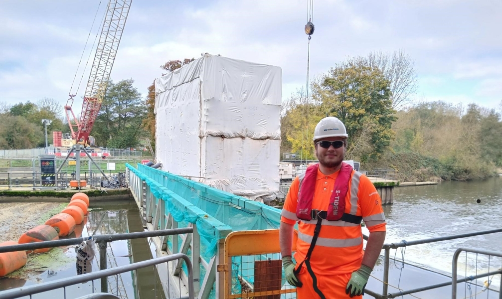 Person in PPE on a bridge. 