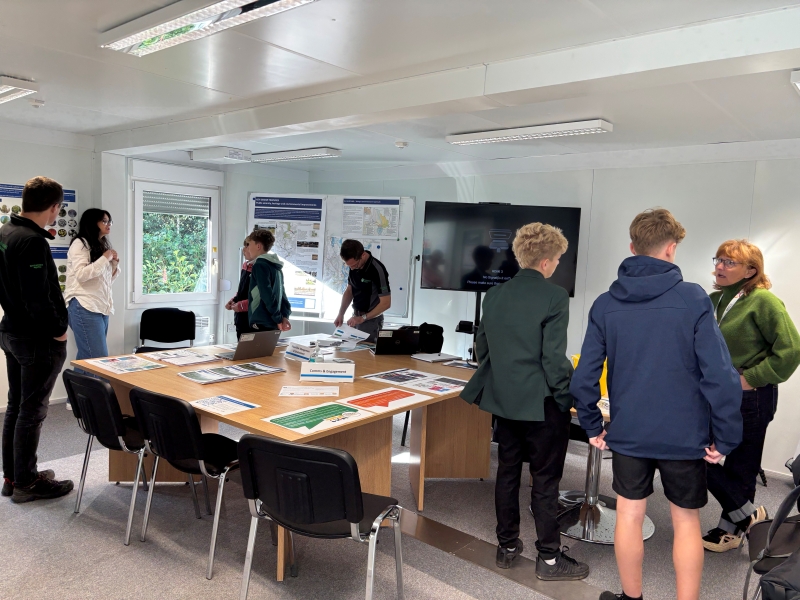 school pupils and Kendal project staff stood talking around a large table