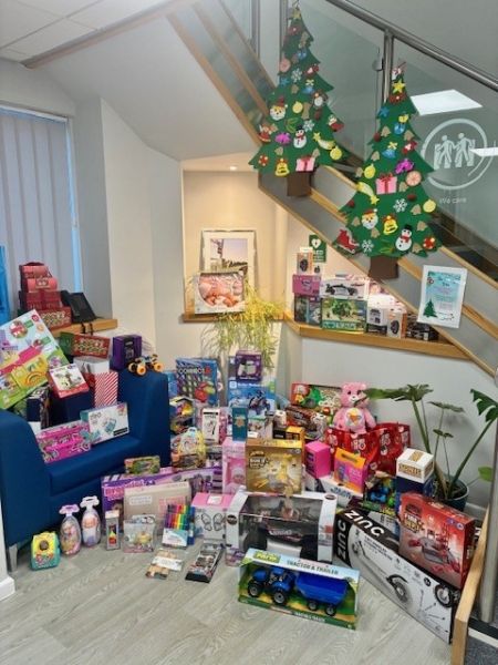 People stood with gifts for a charity.