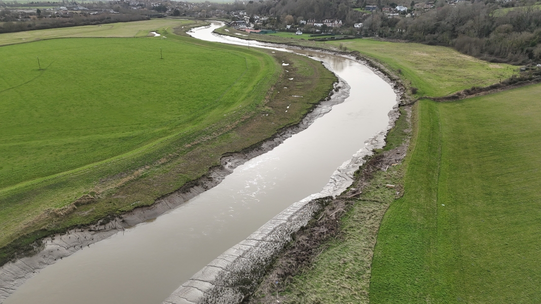 River running next to fields.