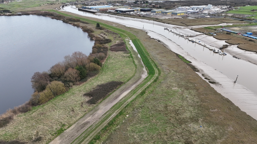 River running next to fields.