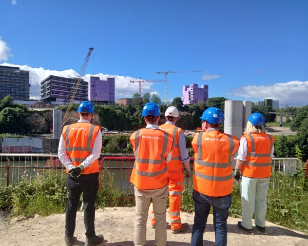 People in highvis on a site tour of the New Wear high-level Footbridge.