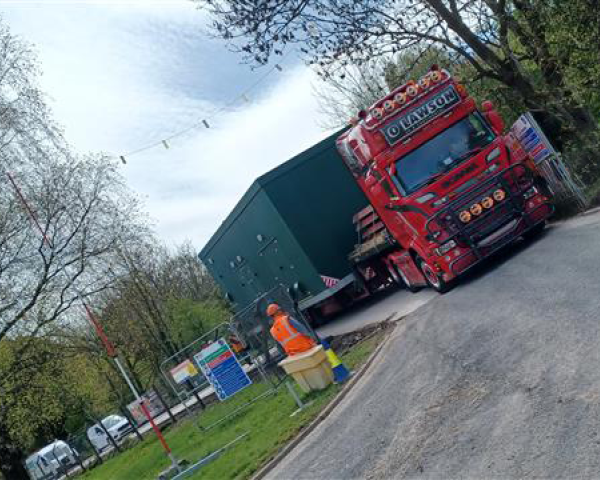 Truck delivering a new kiosk to site.
