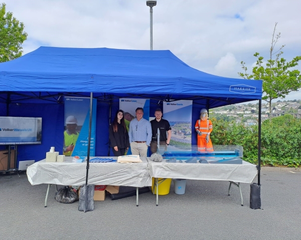 People stood outside under a gazebo at a careers fair.