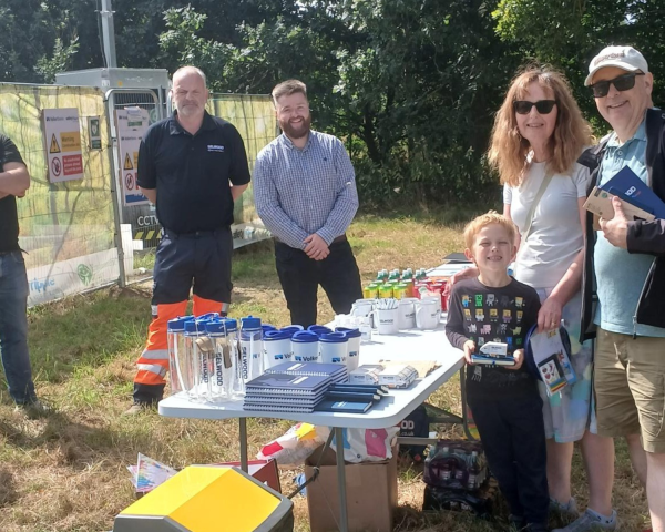 People stood around a table smiling.