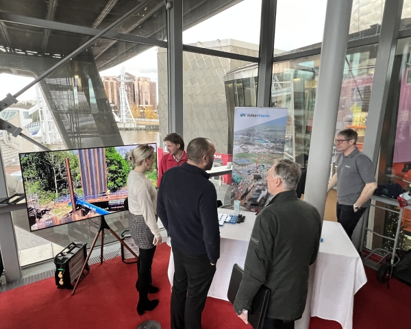People gathered around an exhibition stand