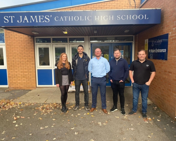 Men and women stood outside a school entrance