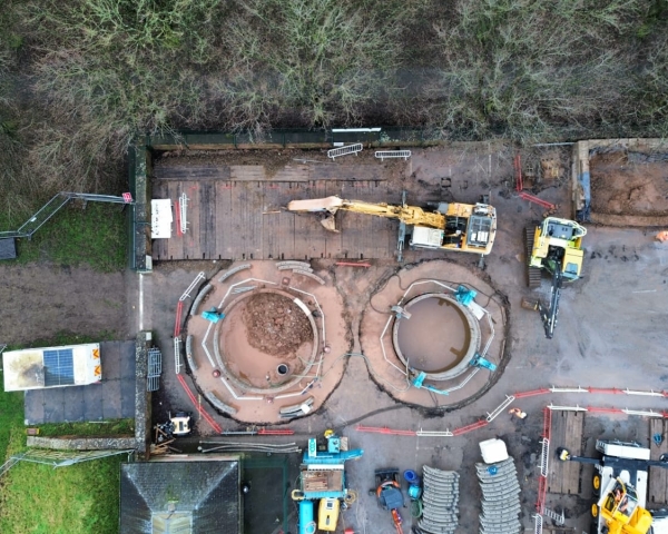Picture of two diggers next to two large holes.