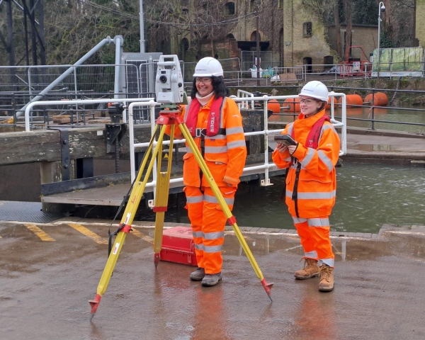 Two people on site smiling.