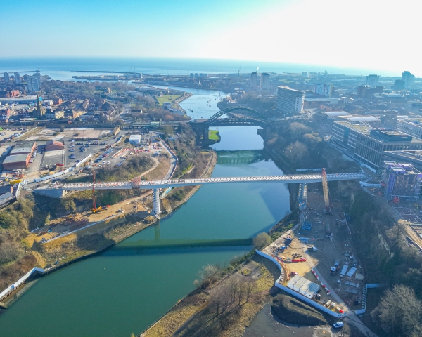 aerial of footbridge in construction across the river