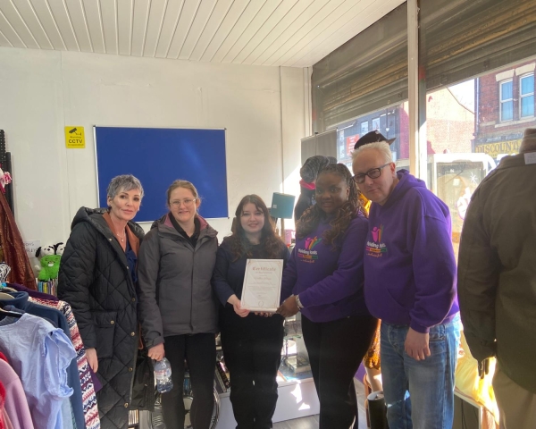 People stood in a charity shop