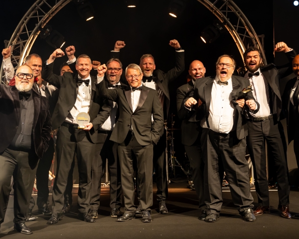 People in suits on a stage.