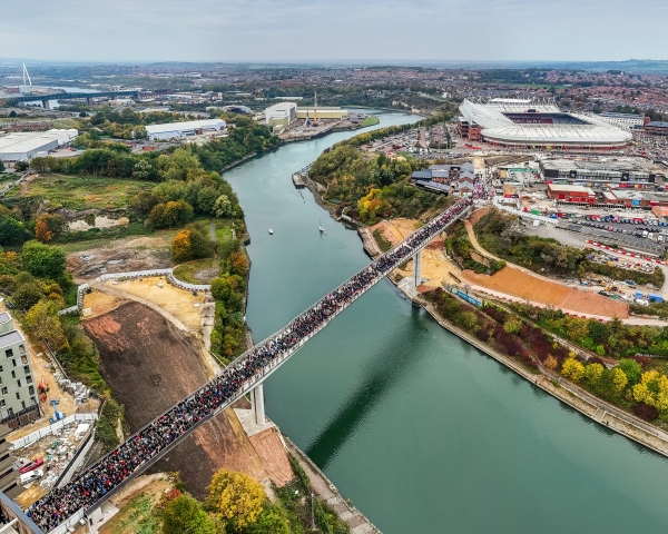 Keel Crossing opening - aerial image of bridge across the River Wear with large group of people walking across it