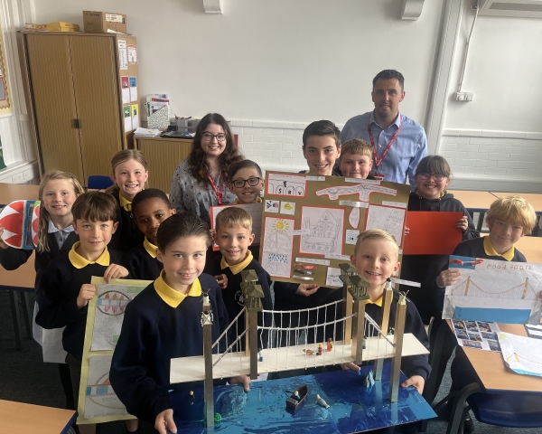 Children in a classroom with model bridges