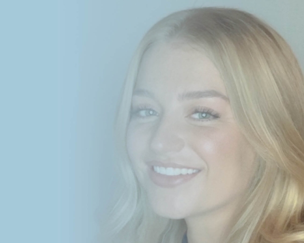 Girl with blonde hair smiling.