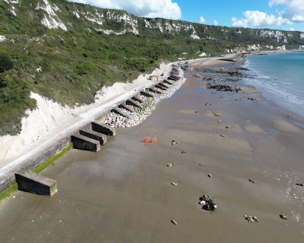 Picture of people stood on a beach.