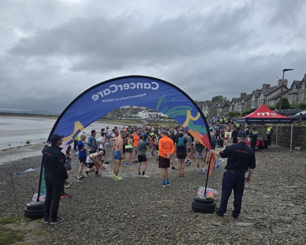 people on a beach with a banner in the foreground