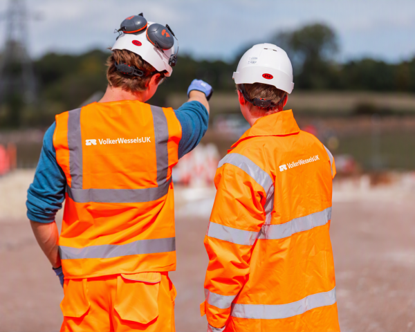 Two men in highvis pointing