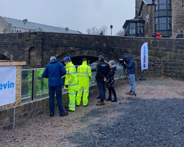 ITV BOrder, Cumberland Council , Kendal Town Council and EA representatives viewing the first glass panels.jpg