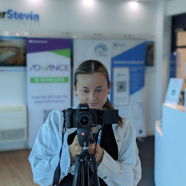 Picture of girl filming with a camera.