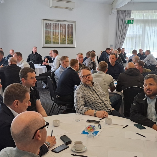 People sat around tables at an event.