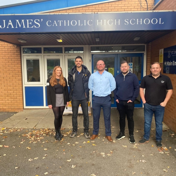 Men and women stood outside a school entrance