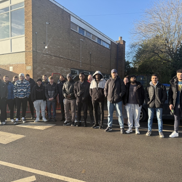 Group of men and women outside a construction site