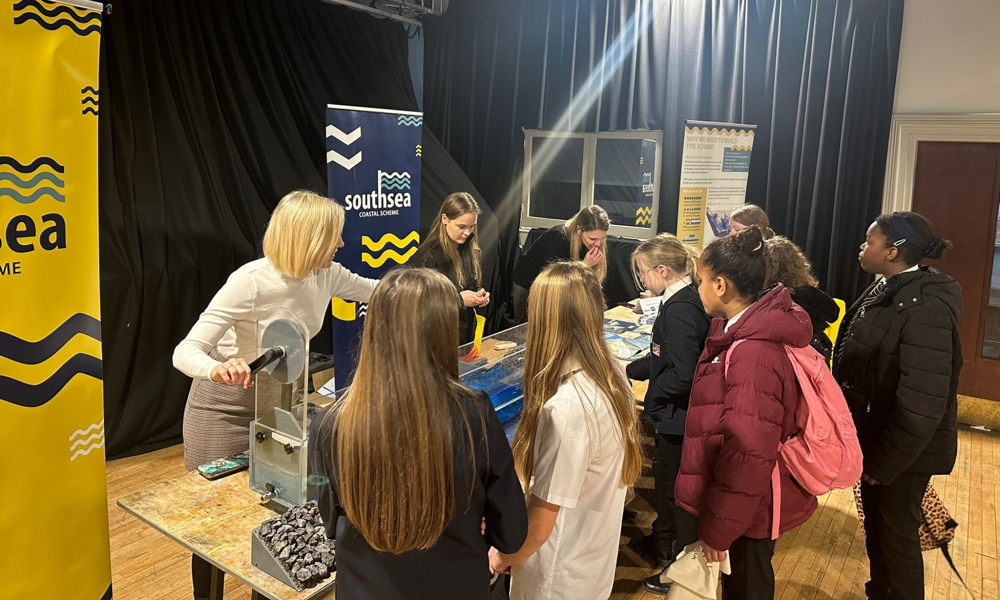 Women stood with school children demonstrating a wave machine