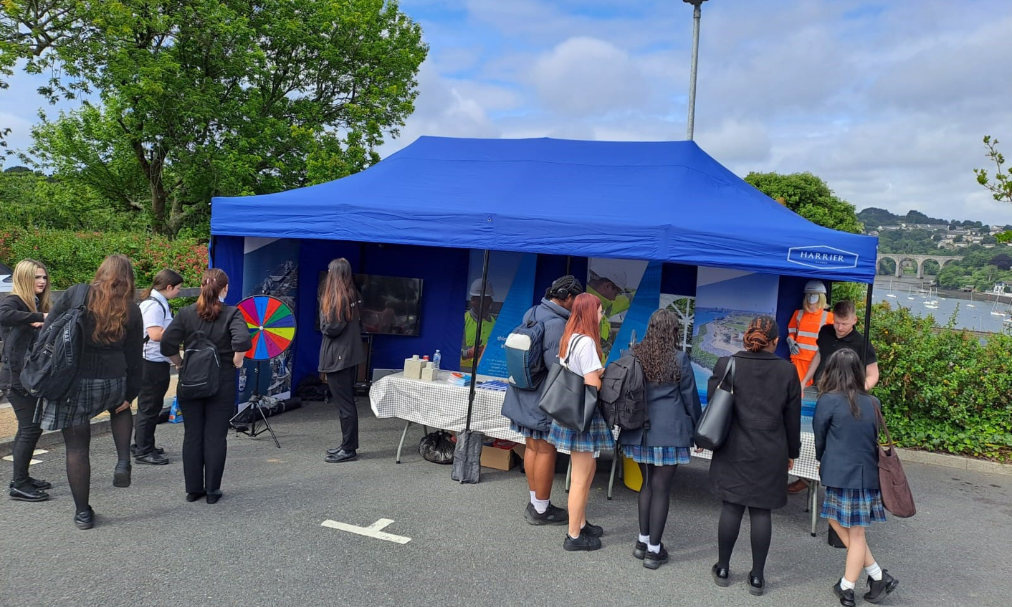 People stood outside under a gazebo at a careers fair.