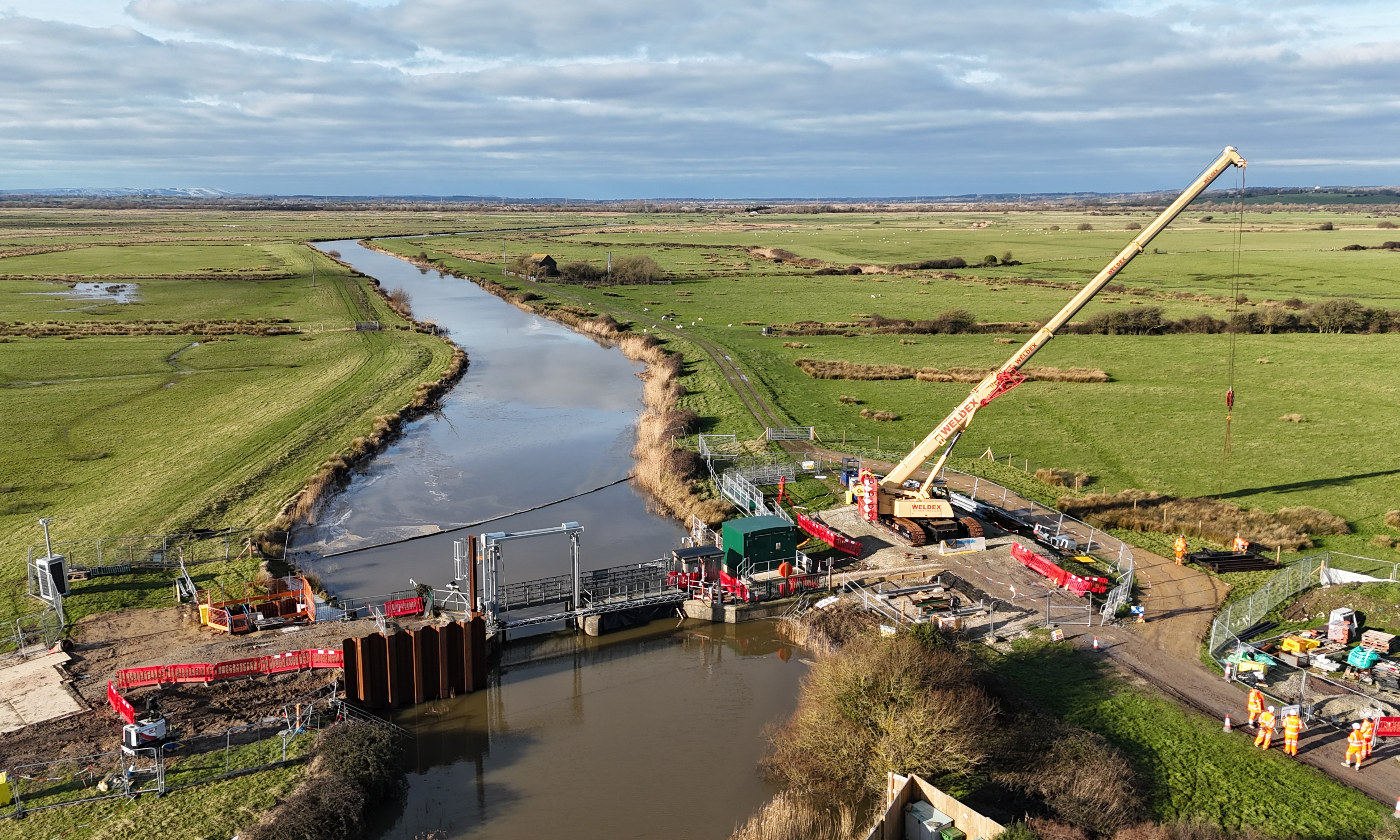 Picture of a river with a bridge and crane.