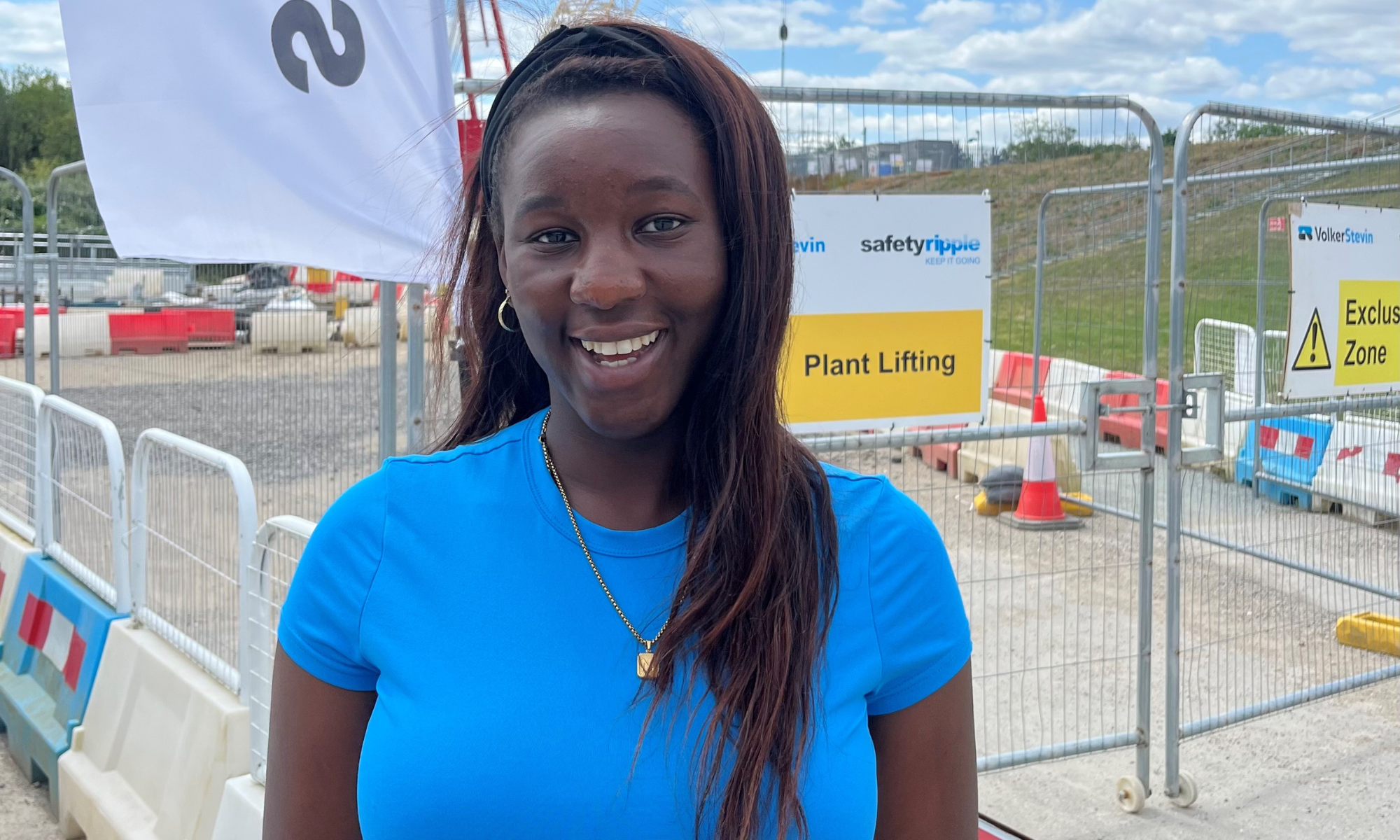 Picture of a girl in a blue top smiling.