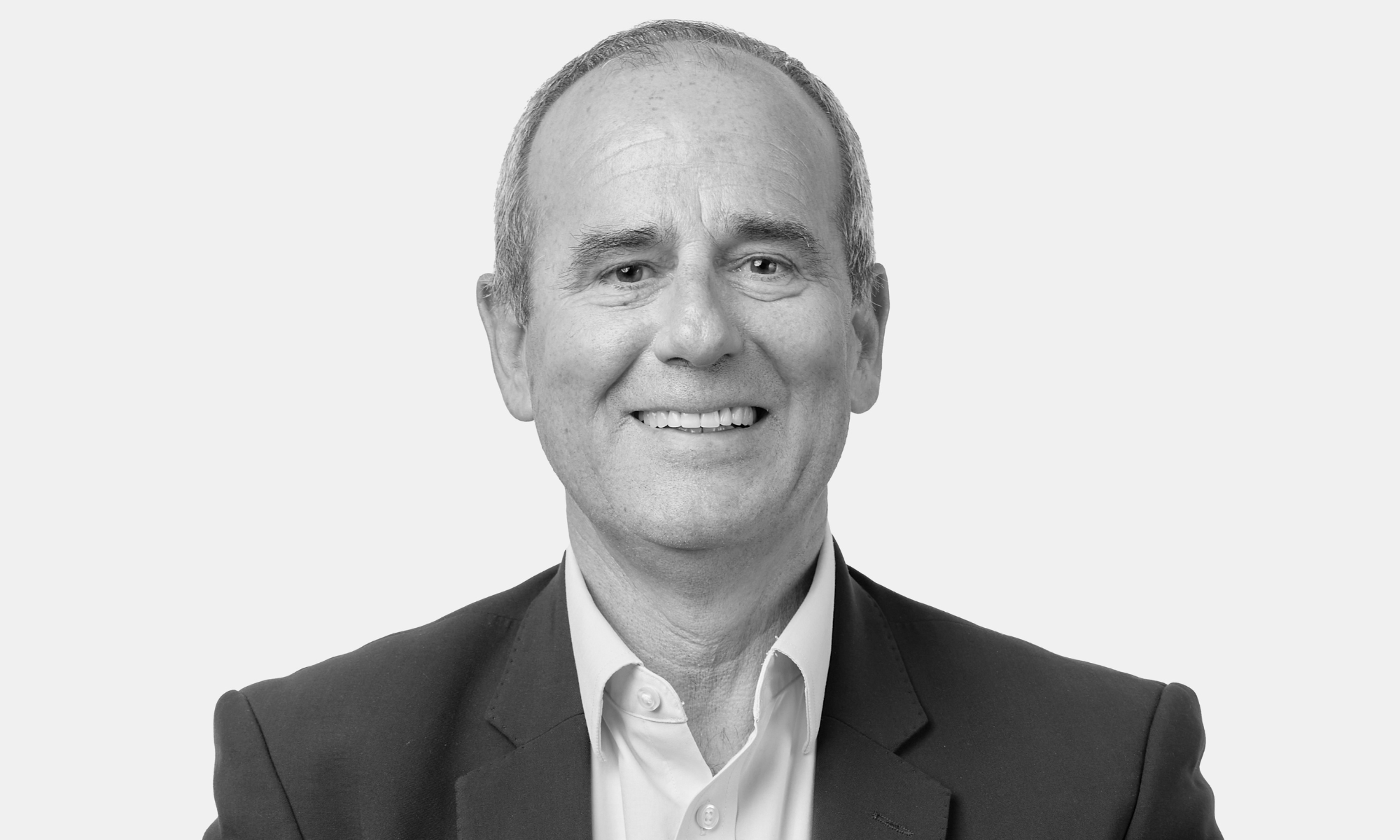 Picture of a man smiling. Our Leadership Team